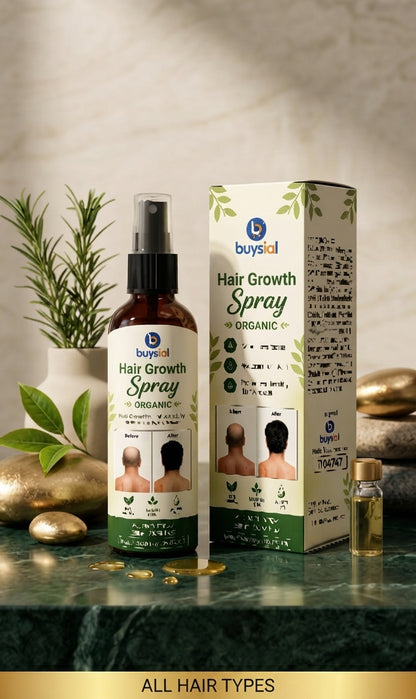 A bottle and box of buysal Hair Growth Spray Organic displayed on a dark green marble surface with decorative gold coins, a small vial, and a potted plant in the background.