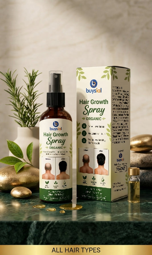 A bottle and box of buysal Hair Growth Spray Organic displayed on a dark green marble surface with decorative gold coins, a small vial, and a potted plant in the background.